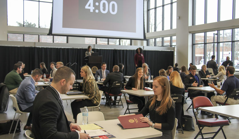 CMU Sales Challenge with students sitting at tables being interviewed by employers.